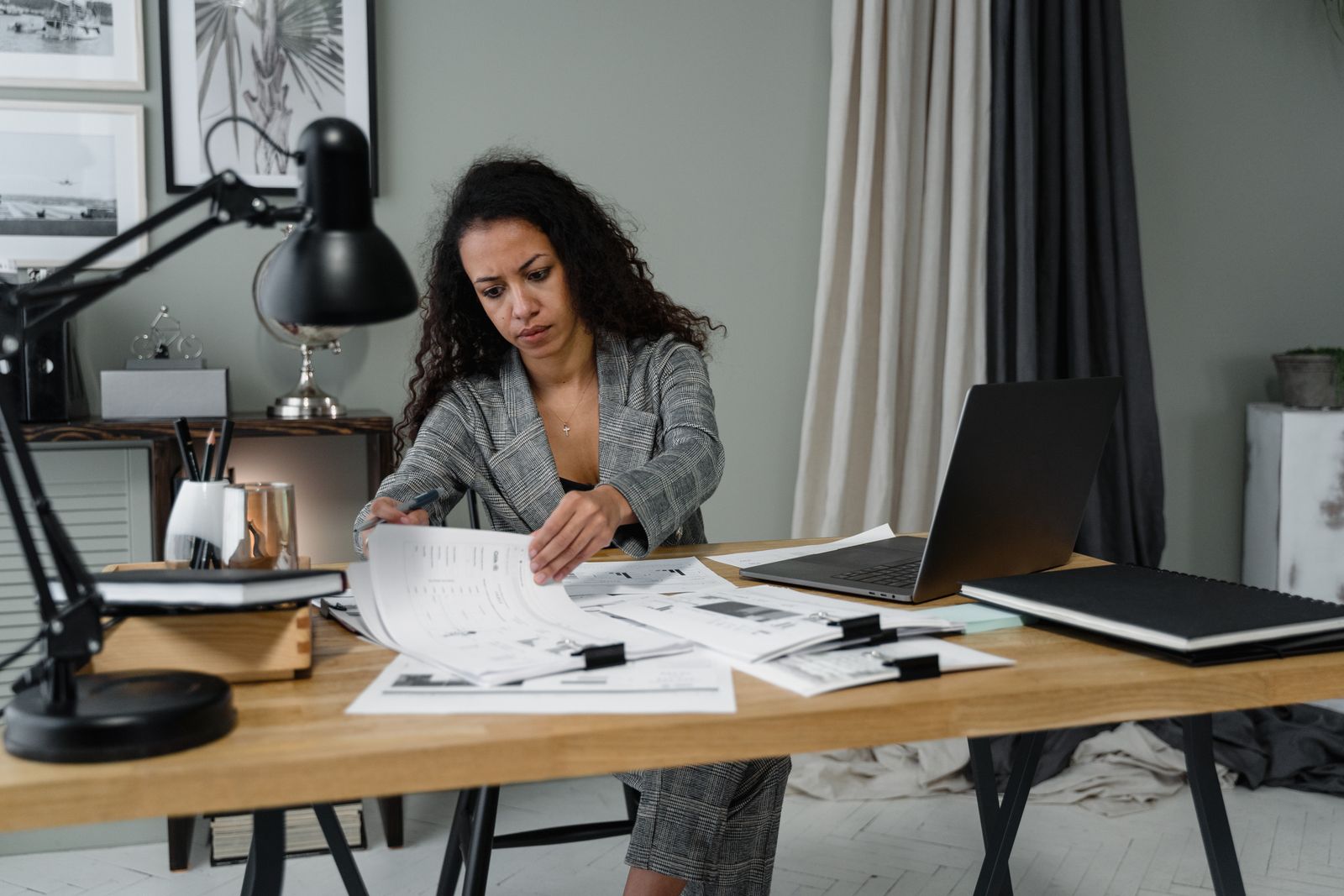 Professional reviewing documents on a laptop in an office